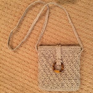 Taupe woven cross body bag. Tortoise shell clasp